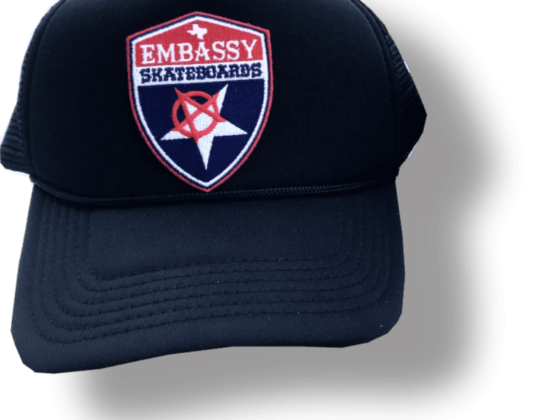 Embassy Shield Logo on Black Trucker Cap